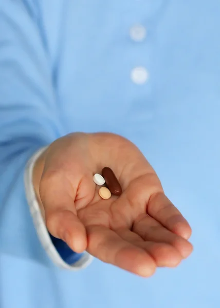 Woman hold pills in hand