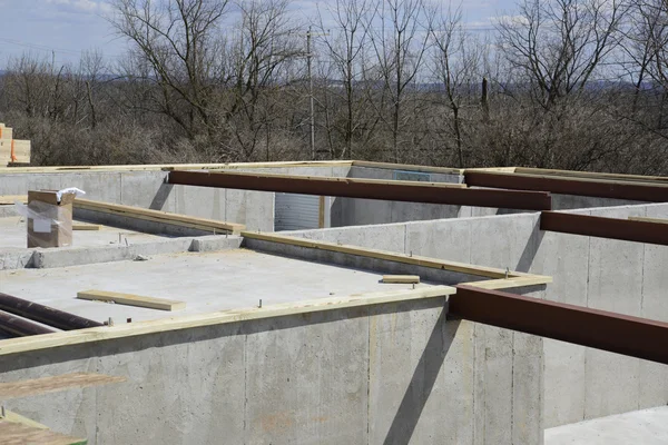 Concrete foundation with steel beams for the floor joist