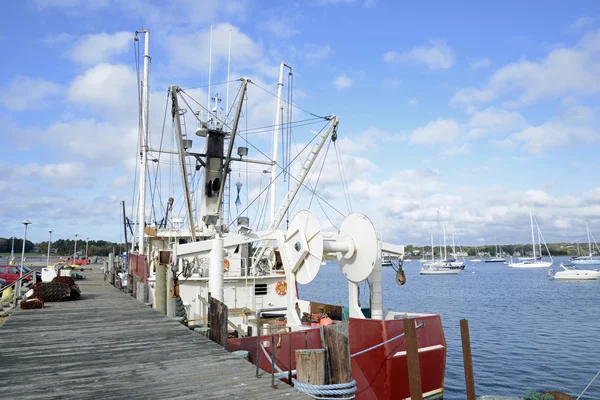 Commercial fishing boats by a wood dock