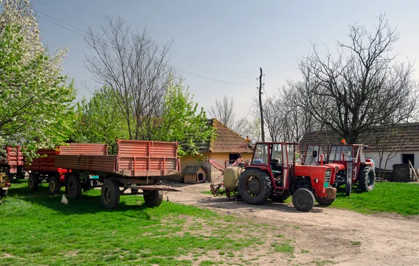 Tractors and trailers on the old fashioned farm