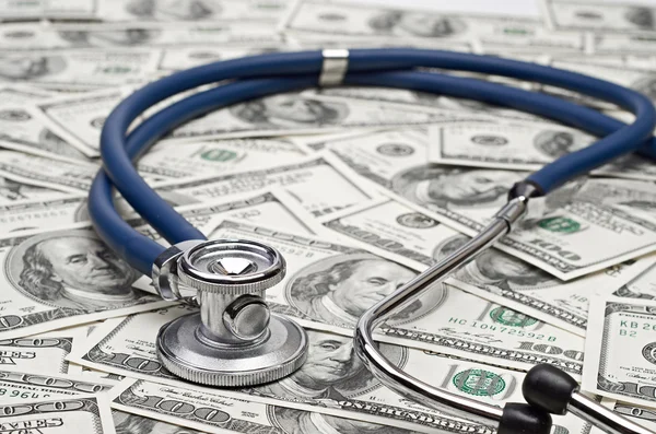 Heap of dollars with stethoscope