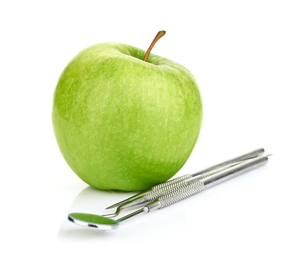 Green apple and dental tools