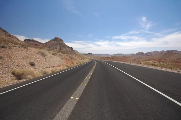 Deserted road stretching toward the horizon in the Valley of Fire State Park, Nevada