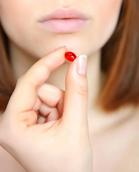Young woman taking the capsule