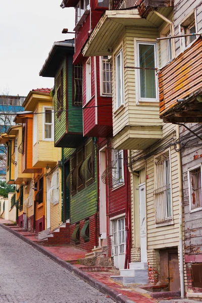 Colorful street scene with very narrow house painted. Historic houses in Istanbul, Fatich.