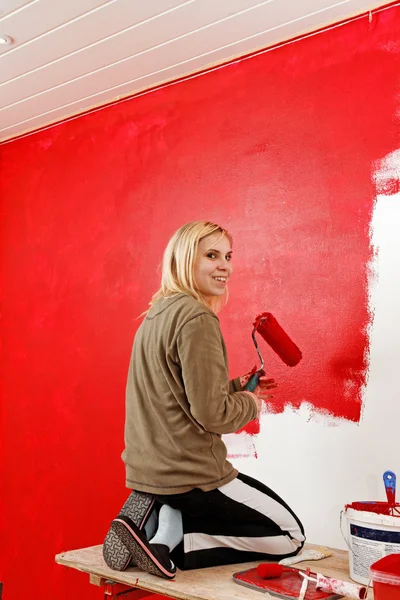 Girl with paint roller.