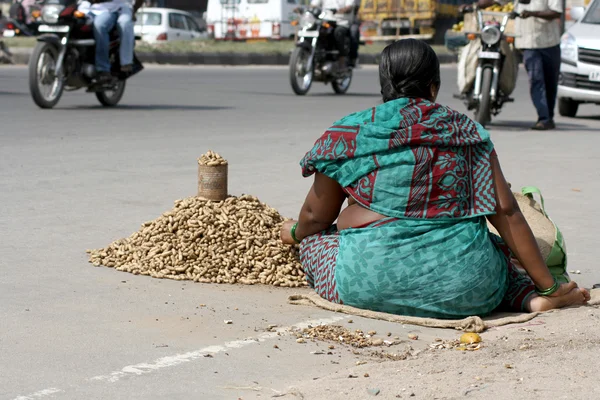 Poor indian street vendor sell peanuts