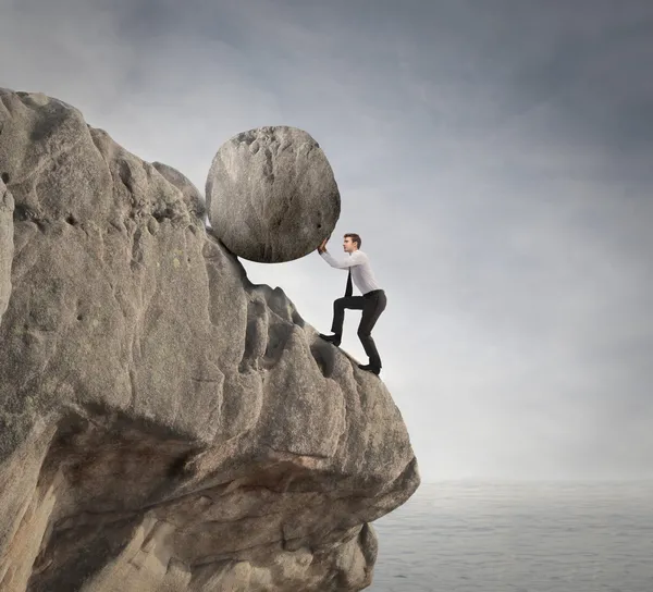 Businessman holding a rock