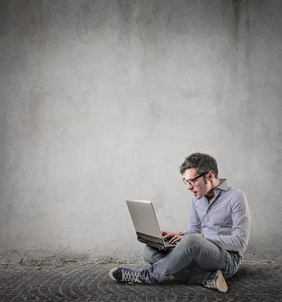 Surprised man working on his laptop