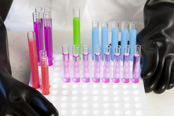 Detail of woman with test tubes in laboratory