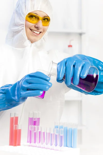 Young woman wearing protective coat in laboratory