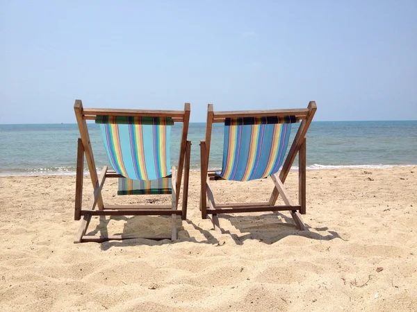 Two lounge chairs on the beach