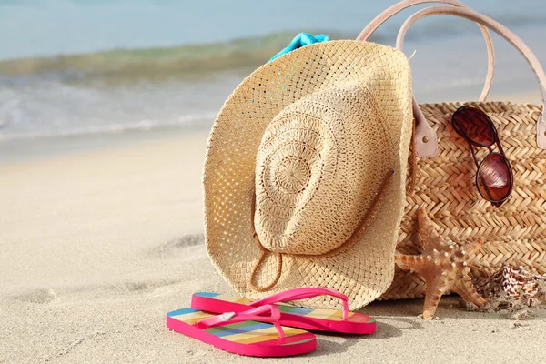 Summer beach bag on sandy beach