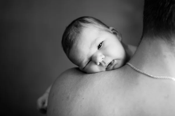 Portrait of a father and newborn daughter