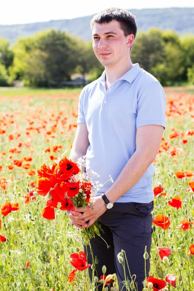 Young man with bouquet of poppies