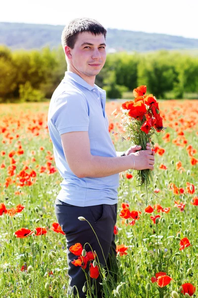 Young man with bouquet of poppies