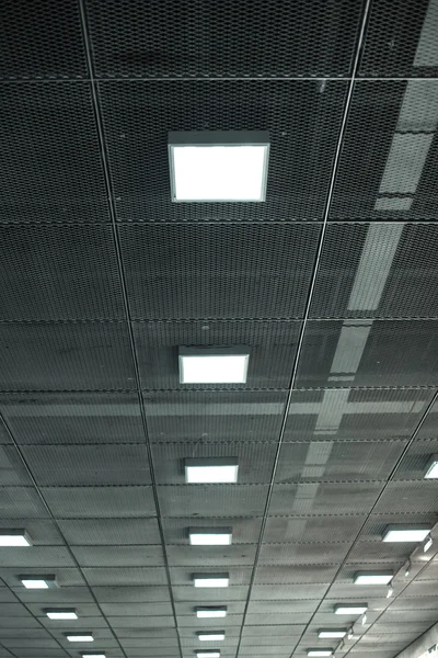 Fluorescent lamp on the modern ceiling