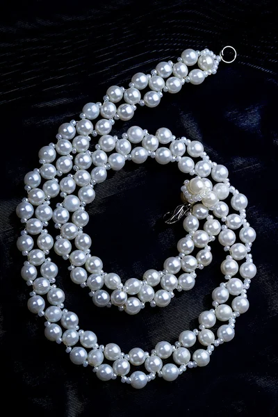 White beads on a black cloth