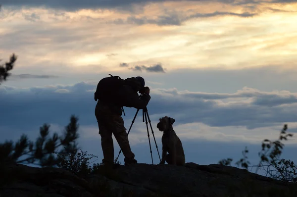 Photographer and dog silhouettes