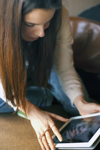 Girl looking at tablet in cafe showing emotion