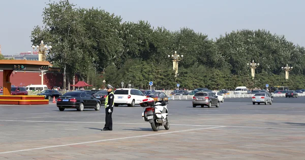 Police officer with bike on the road in central Beijing, China
