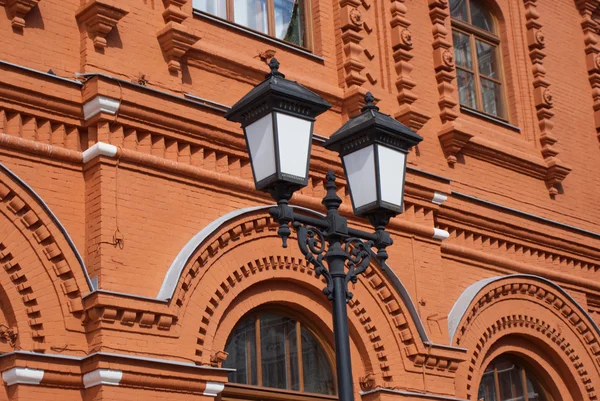 Lighting lantern before red bricks retro styled building