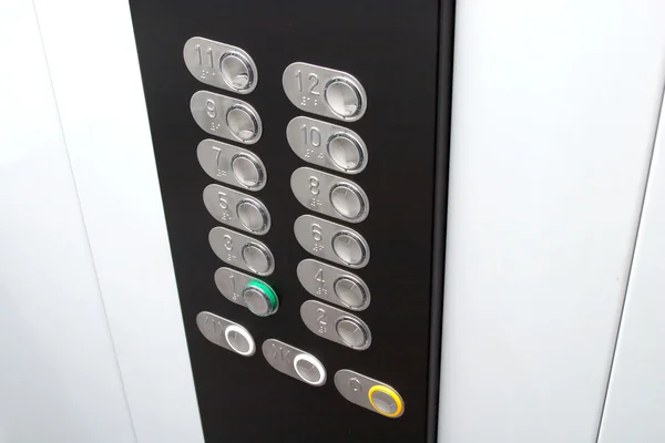 Control panel in elevator cabin with metal buttons