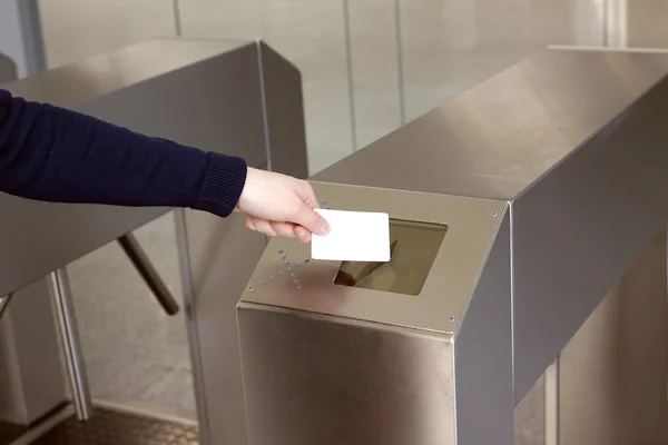 Woman's hand puts white plastic card to reader closeup