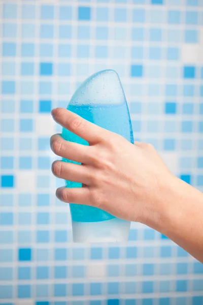 Hand holding shower gel
