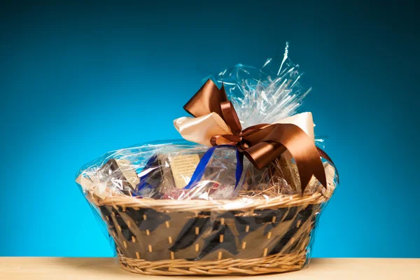 Gift in a basket against blue background