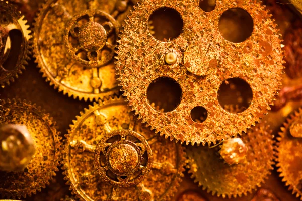 Aged golden gear wheels