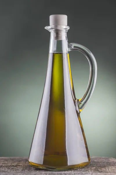 Olive oil bottle with green spotlight background