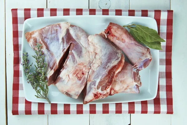 Uncooked lamb leg with rosemary and garlic