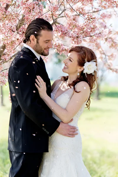 Bridal Couple Showered by Cherry Blossom Petals