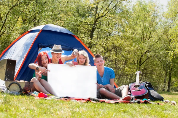 Youth on a camping with an empty sign board