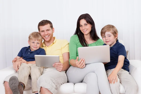 Happy family using laptop at home