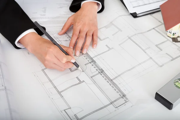 Closeup Of Architect Working On Blueprint