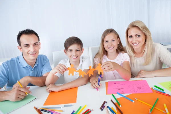 Family Holding Paper In Hand