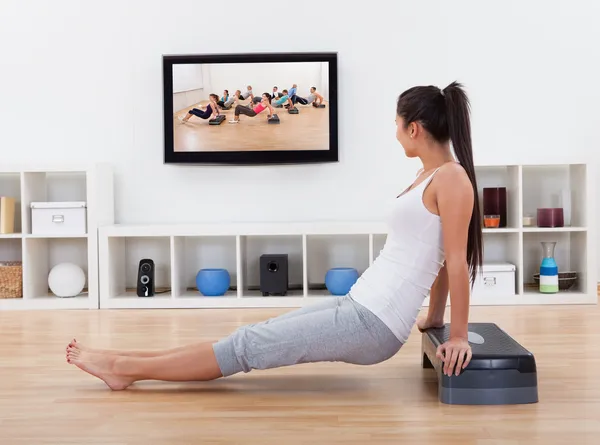 Athletic woman doing exercises in her livingroom