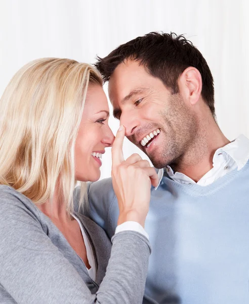 Woman touching her husband on the nose