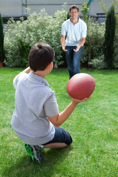 Father and son playing american football