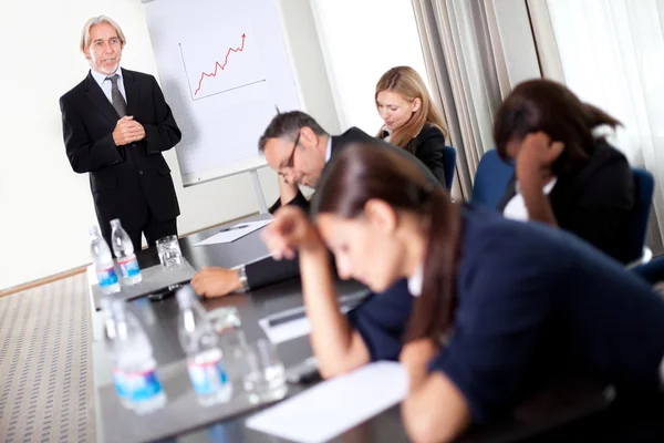 Businessman at a sales meeting discussing targets