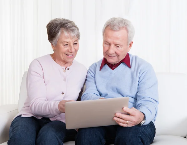 Senior Couple Looking At Laptop Computer