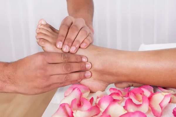 Hand Massaging Foot In Spa