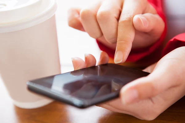 Close-up of hand using cell phone