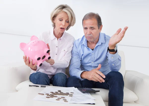 Shocked Couple Holding Piggybank
