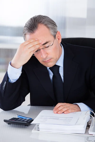 Businessman With Headache In Office