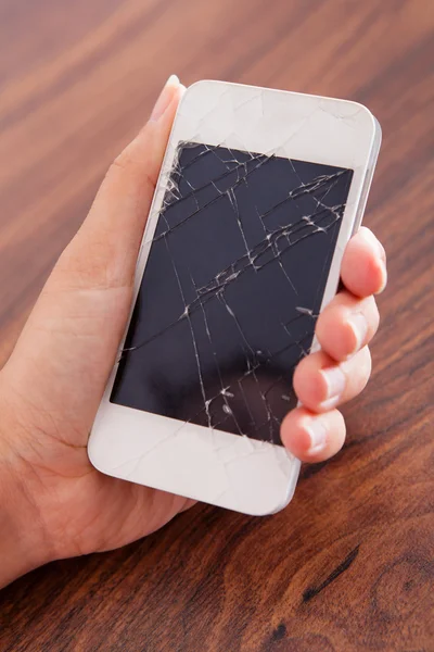 Hand Holding Smartphone With Cracked Screen