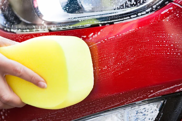 Hand Washing Red Car With Yellow Sponge