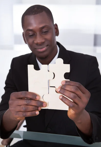 Businessman Holding Jigsaw Puzzle